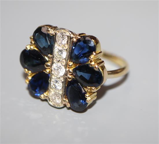 A modern 18ct gold, sapphire and diamond stylised flowerhead ring, size M.